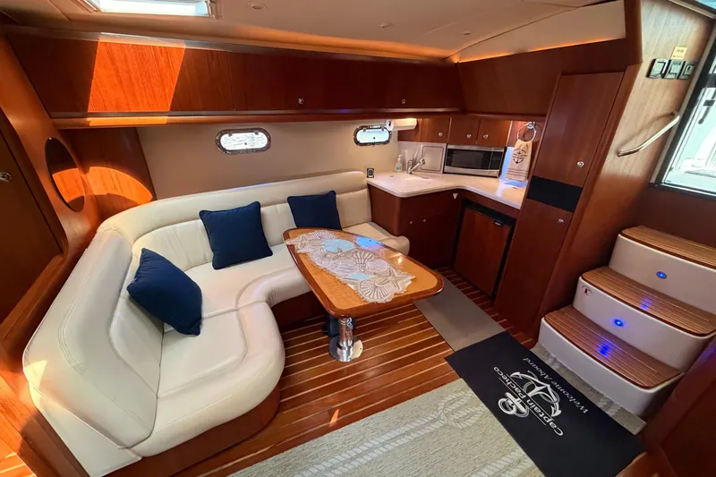 Slide: The Image of Luxurious 2005 Tiara Yachts 3600 Sovran interior with elegant seating and modern kitchenette. - 22
