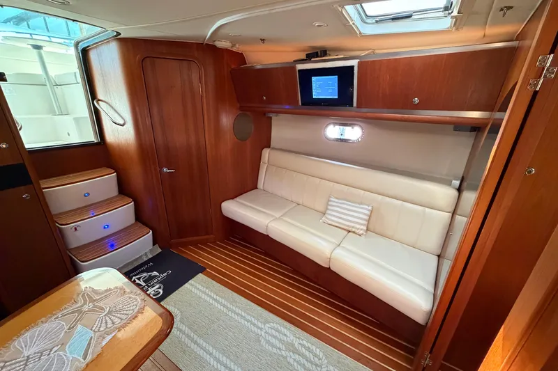 Slide: The Image of Luxurious interior of 2005 Tiara Yachts 3600 Sovran with elegant wood finish and cozy seating. - 23