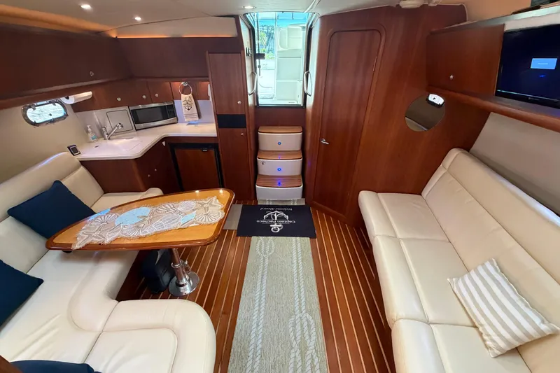 Slide: The Image of Luxurious interior of a 2005 Tiara Yachts 3600 Sovran with elegant seating and kitchenette. - 25