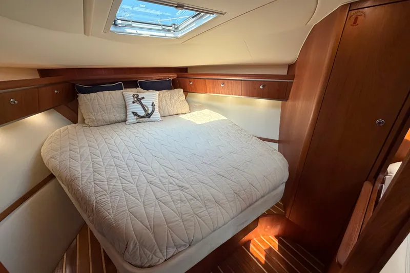 Slide: The Image of Luxurious cabin interior of 2005 Tiara Yachts 3600 Sovran with cozy bedding and wood accents. - 26