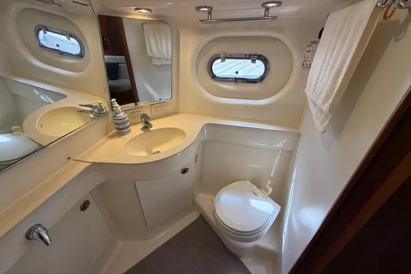 Slide: The Image of Luxurious bathroom in 2005 Tiara Yachts 3600 Sovran, featuring sink, toilet, and porthole window. - 30