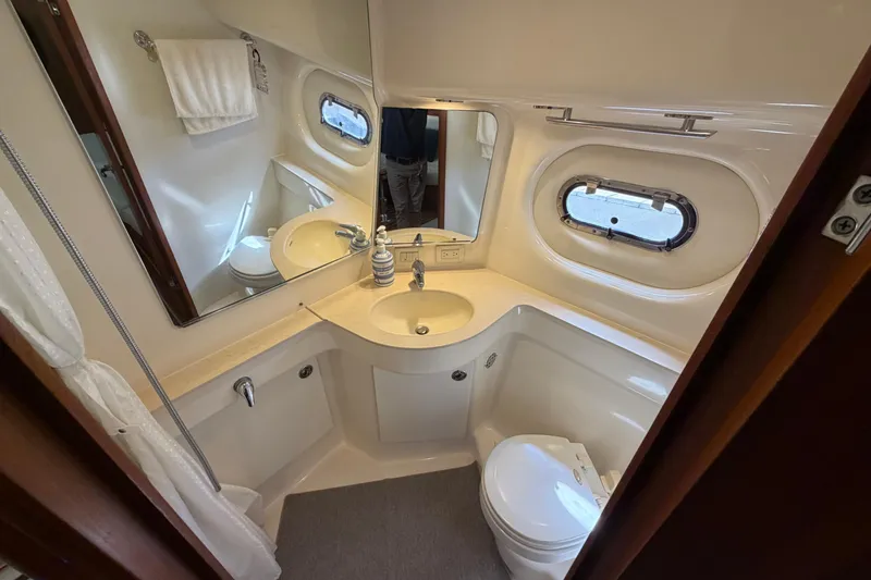 Slide: The Image of Luxurious bathroom in 2005 Tiara Yachts 3600 Sovran, featuring modern fixtures and porthole window. - 31