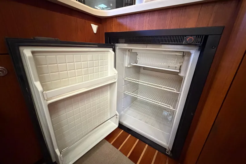 Slide: The Image of Open refrigerator inside 2005 Tiara Yachts 3600 Sovran, showcasing interior shelves. - 33