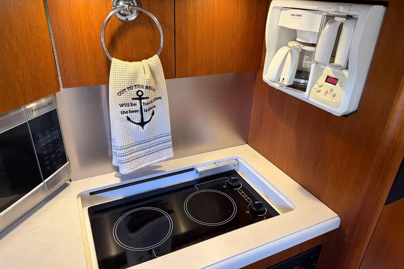 Slide: The Image of 2005 Tiara Yachts 3600 Sovran kitchen with stove, coffee maker, and towel. - 34