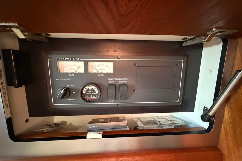 Slide: The Image of Control panel of a 2005 Tiara Yachts 3600 Sovran, featuring volt and amp meters. - 38