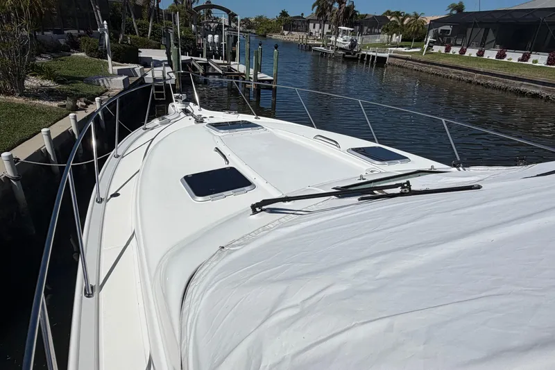 Slide: The Image of 2005 Tiara Yachts 3600 Sovran docked in a scenic canal setting. - 4