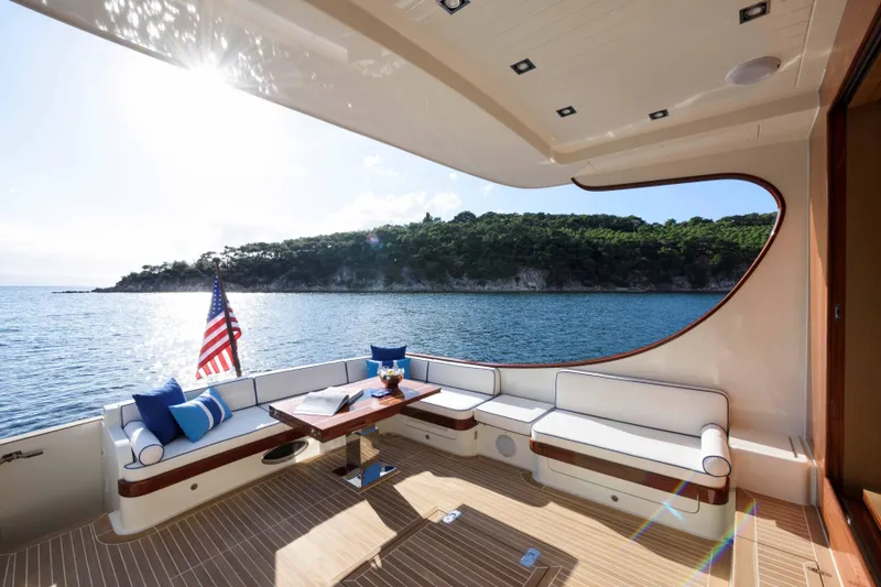 Slide: The Image of Luxurious 2025 Vicem 65 Classic yacht deck with scenic ocean view and elegant seating. - 4