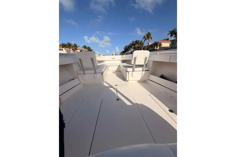 Slide: The Image of 2017 Invincible 39 Open Fisherman boat interior with seating, under a clear blue sky. - 11