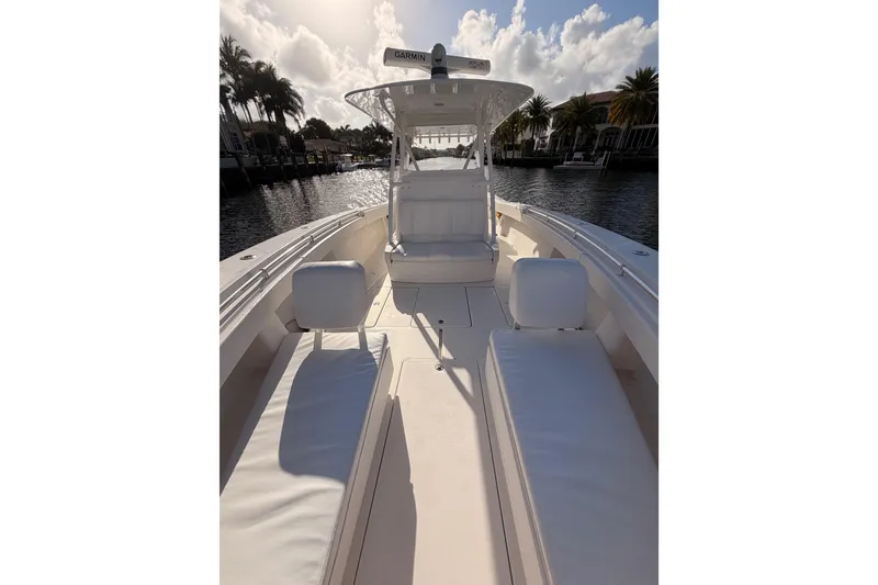 Slide: The Image of 2017 Invincible 39 Open Fisherman boat with white seating, docked on a sunny day. - 13