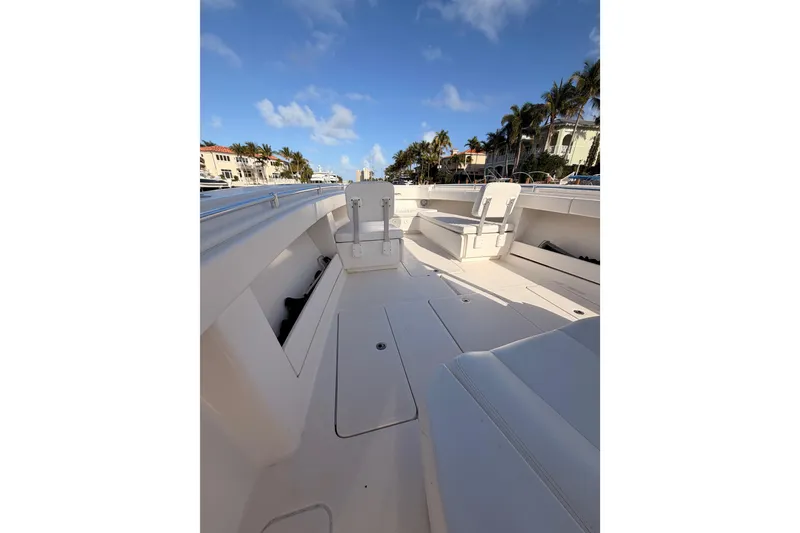 Slide: The Image of 2017 Invincible 39 Open Fisherman boat deck with seating, under a clear blue sky. - 14