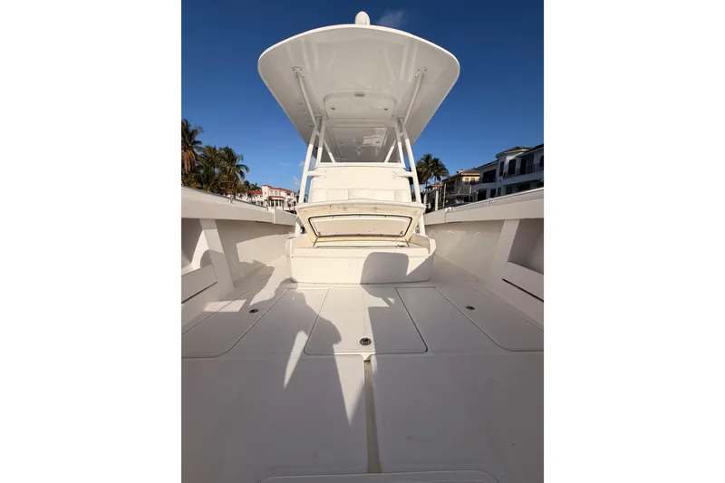 Slide: The Image of 2017 Invincible 39 Open Fisherman boat deck with open storage, clear sky background. - 15