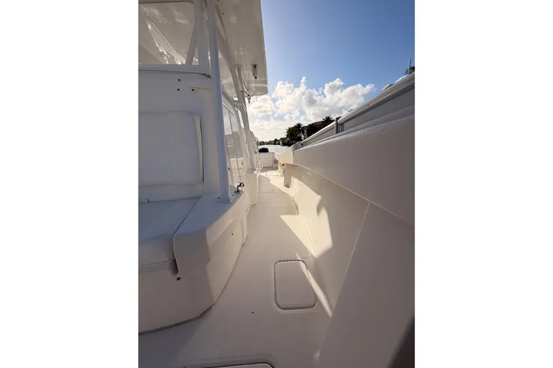 Slide: The Image of 2017 Invincible 39 Open Fisherman boat deck with white seating and clear sky. - 20
