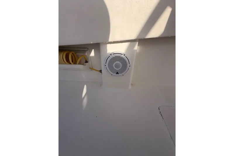 Slide: The Image of 2017 Invincible 39 Open Fisherman boat interior with speaker and coiled hose. - 23