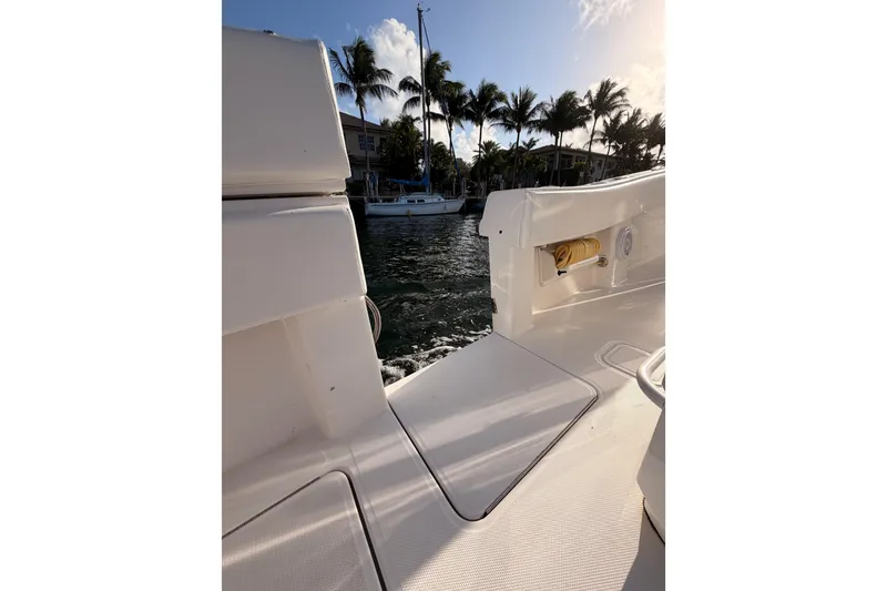 Slide: The Image of 2017 Invincible 39 Open Fisherman boat docked near palm trees and waterfront homes. - 25