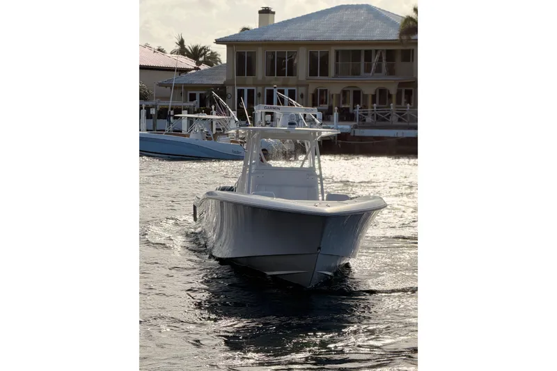 Slide: The Image of 2017 Invincible 39 Open Fisherman boat cruising near waterfront homes. - 3