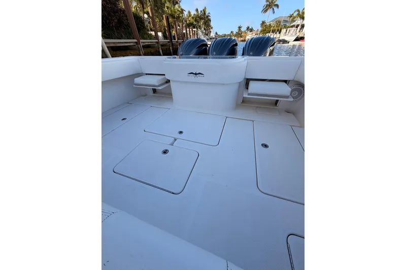 Slide: The Image of 2017 Invincible 39 Open Fisherman boat deck with storage compartments and triple engines. - 32