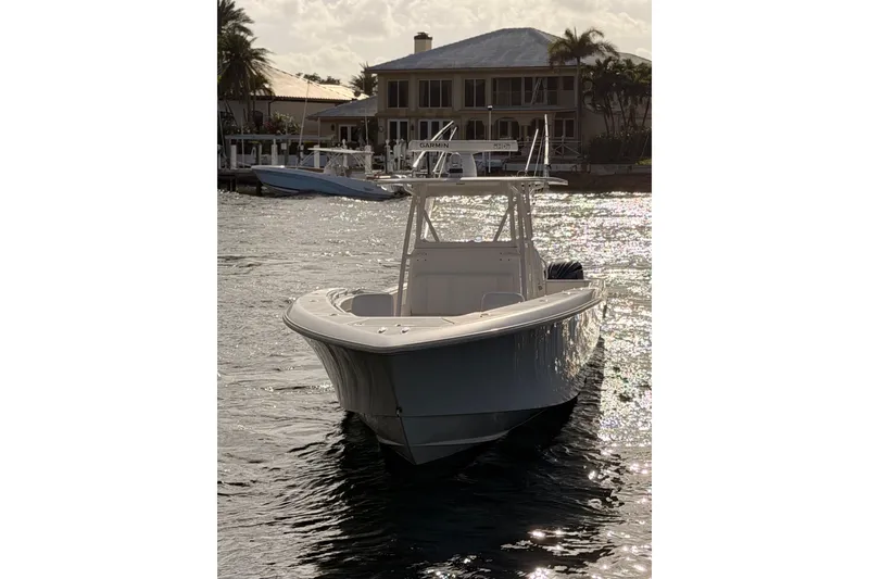 Slide: The Image of 2017 Invincible 39 Open Fisherman boat on water near waterfront home. - 4