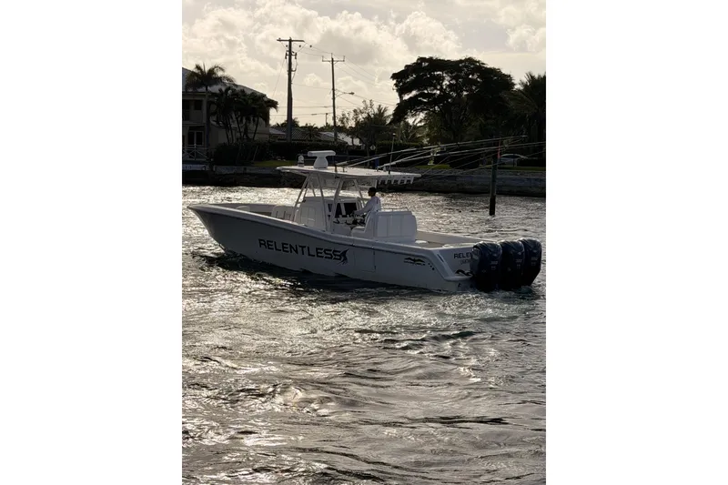 Slide: The Image of 2017 Invincible 39 Open Fisherman boat on water, featuring triple outboard engines. - 6