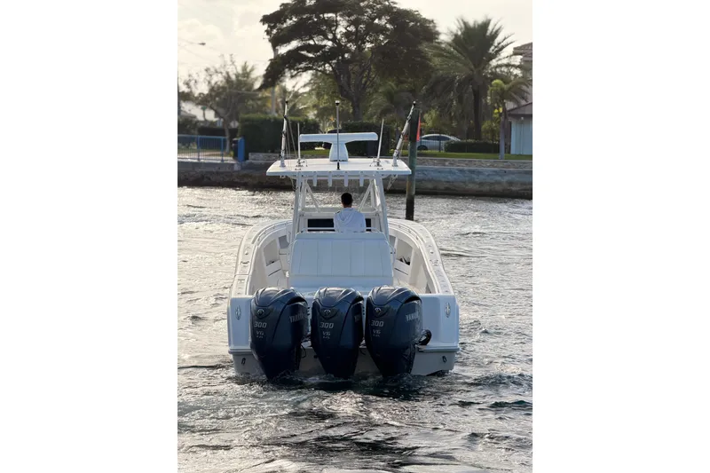 Slide: The Image of 2017 Invincible 39 Open Fisherman boat with triple Yamaha engines on water. - 7