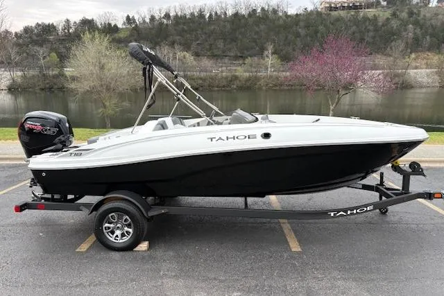 Slide: The Image of 2026 Tahoe T18 boat on trailer by a scenic riverside. - 63