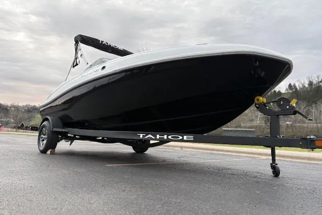 Slide: The Image of 2026 Tahoe T18 boat on trailer, parked outdoors under cloudy sky. - 66