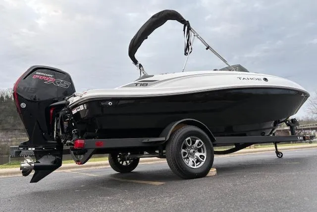 Slide: The Image of 2026 Tahoe T18 boat on trailer with outboard motor, black and white design. - 69