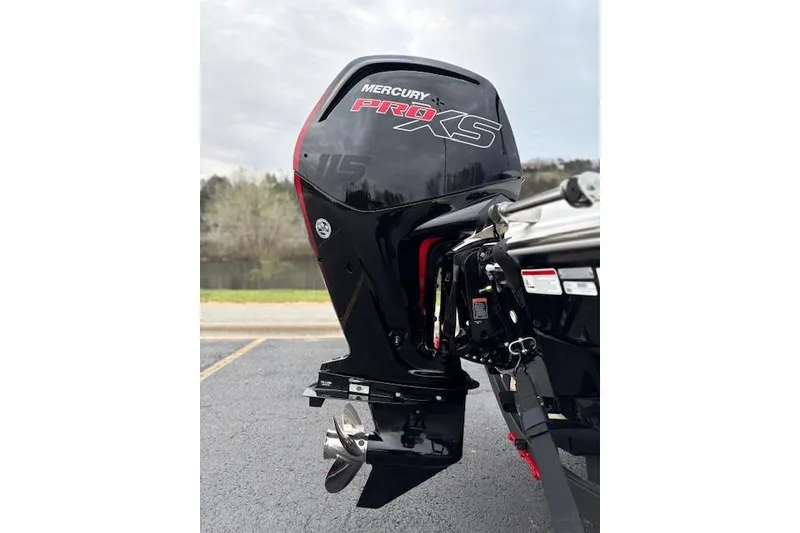 Slide: The Image of Mercury Pro XS outboard motor on 2026 Tahoe T18 boat, parked near a lake. - 70