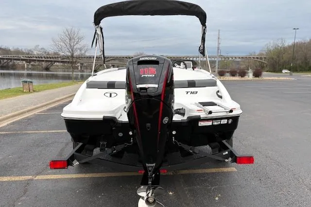 Slide: The Image of 2026 Tahoe T18 boat with Mercury 115 engine, parked near a river. - 73