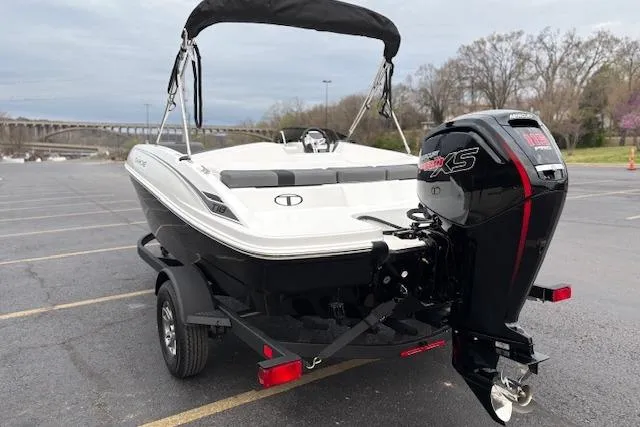 Slide: The Image of 2026 Tahoe T18 boat with outboard motor in a parking lot. - 76