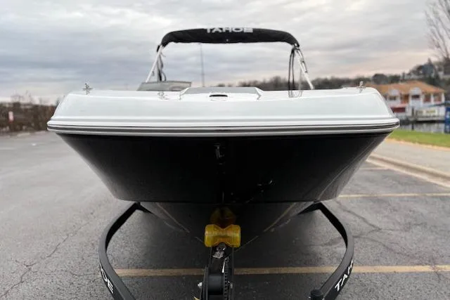 Slide: The Image of 2026 Tahoe T18 boat on trailer, front view, parked outdoors under cloudy sky. - 83