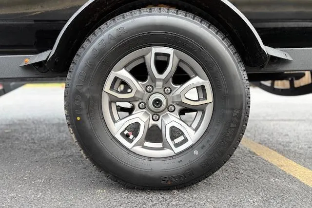 Slide: The Image of 2026 Tahoe T18 wheel with Road Star tire on asphalt surface. - 87