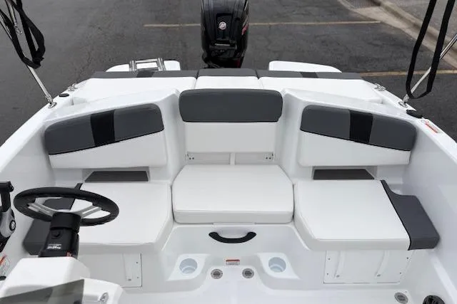 Slide: The Image of 2026 Tahoe T18 boat interior with white and gray seating, steering wheel, and motor. - 91
