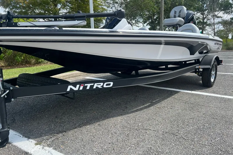Slide: The Image of 2026 Nitro Z17 boat on trailer in parking lot, showcasing sleek design and modern features. - 5