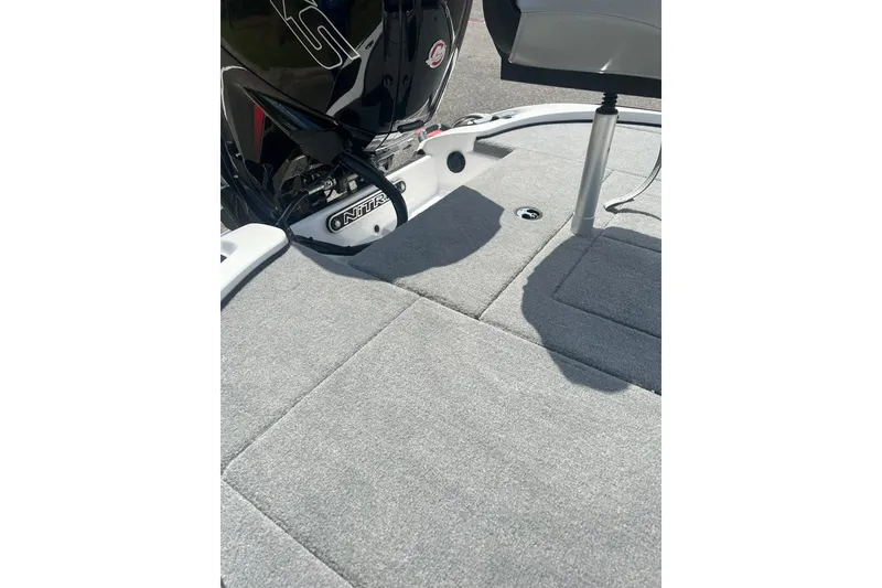 Slide: The Image of 2026 Nitro Z17 boat deck with gray carpet and motor detail. - 12