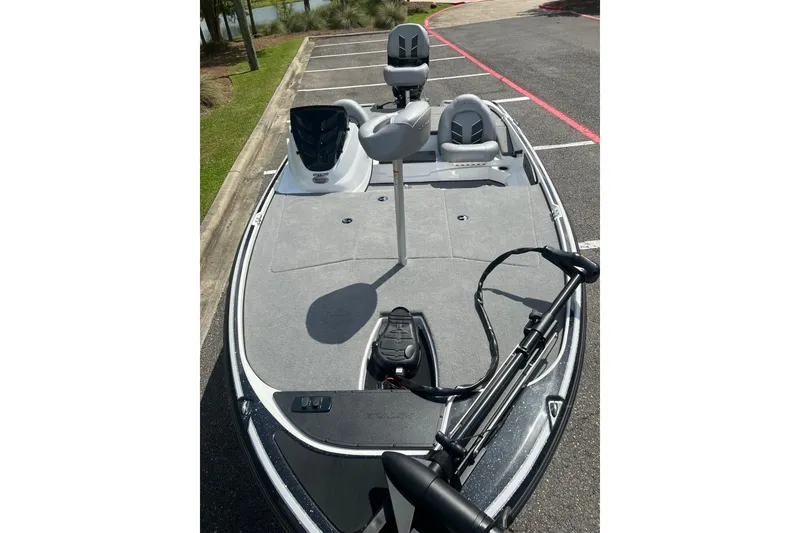 Slide: The Image of 2026 Nitro Z17 fishing boat with spacious deck and seating, parked outdoors. - 6