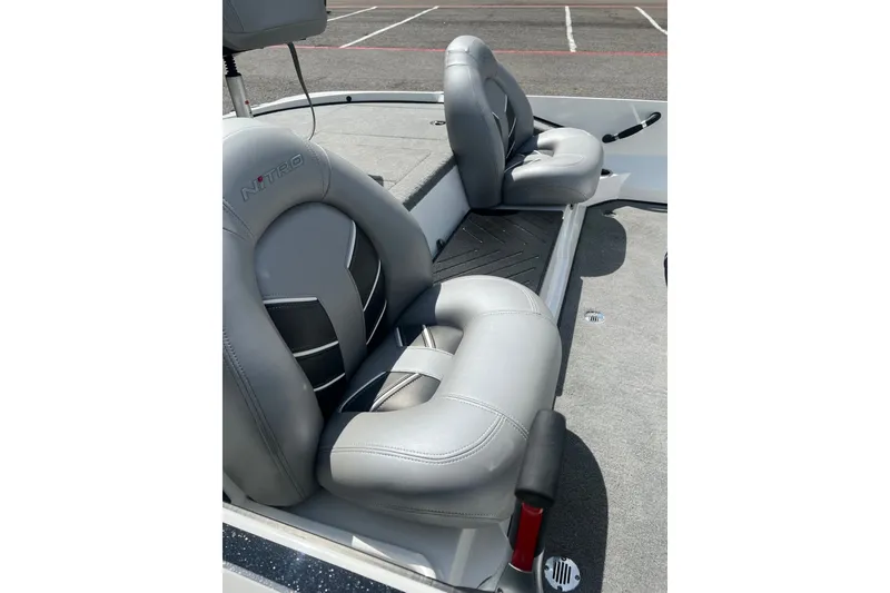 Slide: The Image of 2026 Nitro Z17 boat seats with sleek gray upholstery in a parking lot setting. - 11