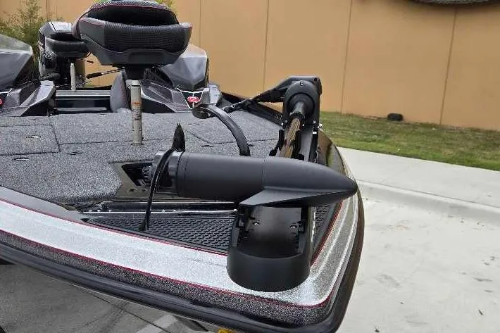 Slide: The Image of 2025 Ranger Z518 boat with trolling motor on deck, parked outdoors. - 9