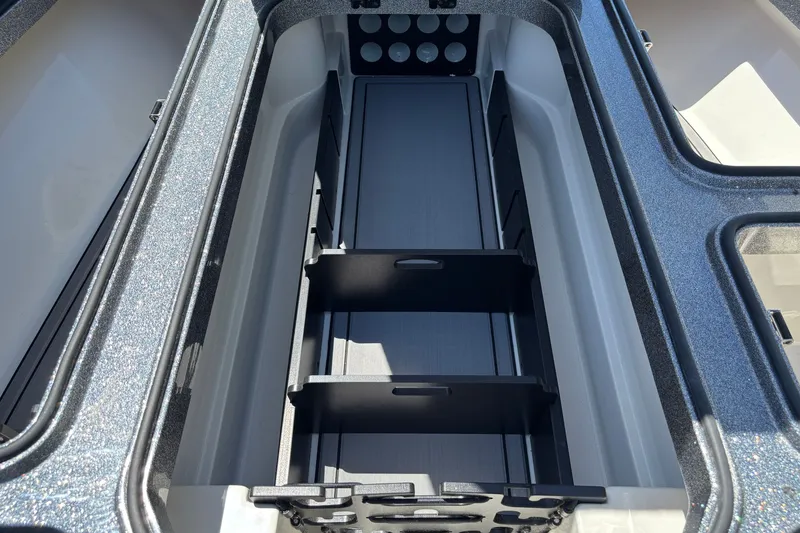Slide: The Image of Interior storage compartment of 2025 Ranger Z518 boat, featuring organized sections and sleek design. - 12
