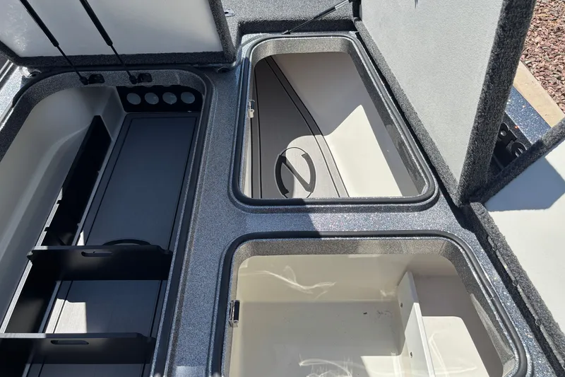Slide: The Image of 2025 Ranger Z518 boat storage compartments with open lids, showcasing spacious interior design. - 13