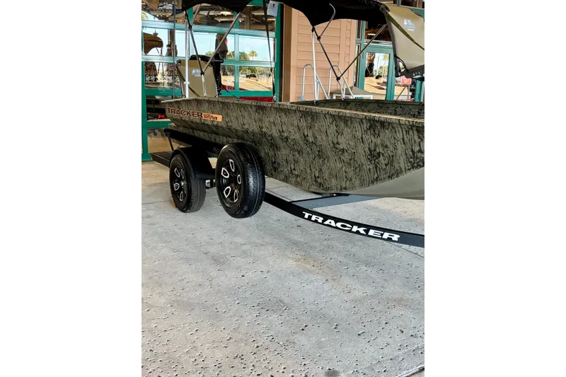 The Image of 2026 Tracker Grizzly 1756 T Marsh boat on trailer, displayed indoors. - 0