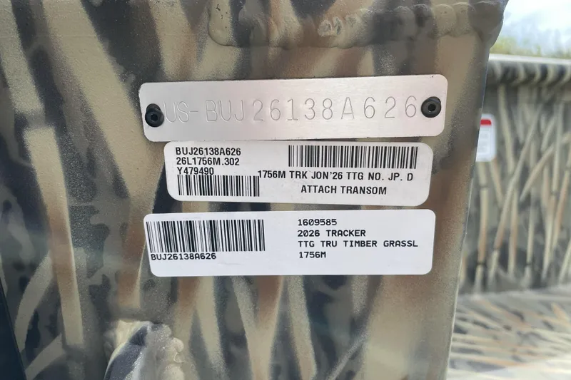 Slide: The Image of 2026 Tracker Grizzly 1756 T Marsh boat identification tags on camouflage background. - 67