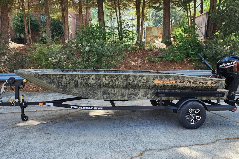 The Image of 2026 Tracker Grizzly 1756 T Marsh boat on trailer, parked outdoors. - 0