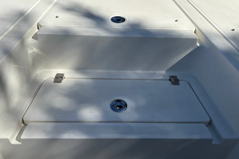 Slide: The Image of Storage compartment on 2026 Mako 24 APEX boat, featuring secure latches and durable design. - 35