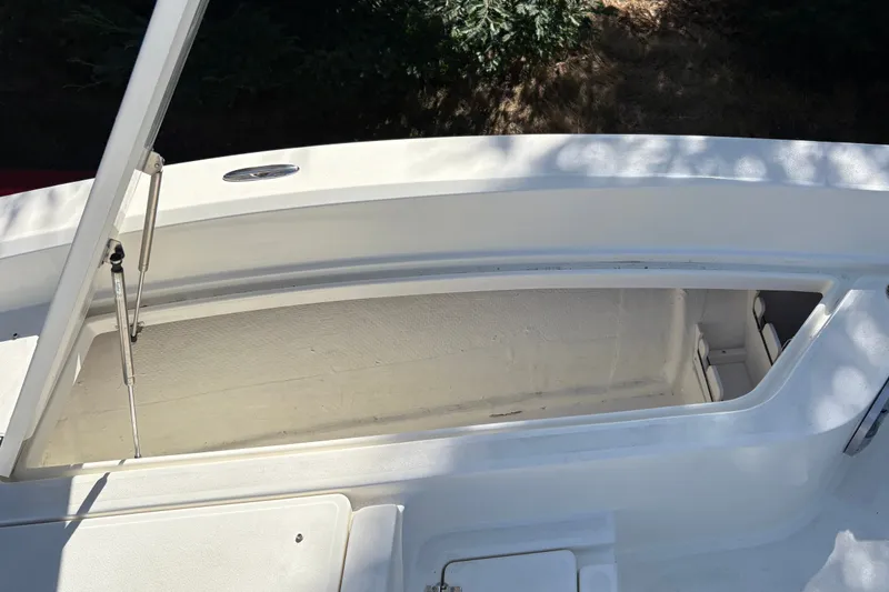 Slide: The Image of Open storage compartment on a 2026 Mako 24 APEX boat, showcasing interior space. - 34