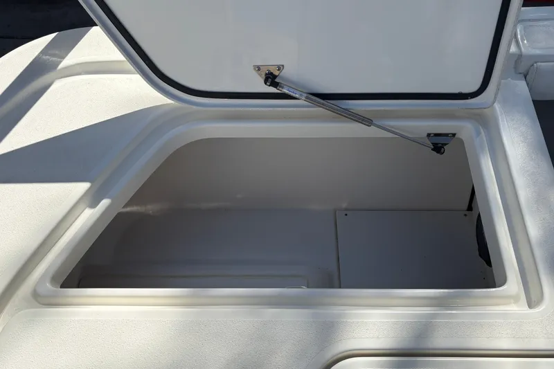 Slide: The Image of Open storage compartment on 2026 Mako 24 APEX boat, showcasing interior space. - 45
