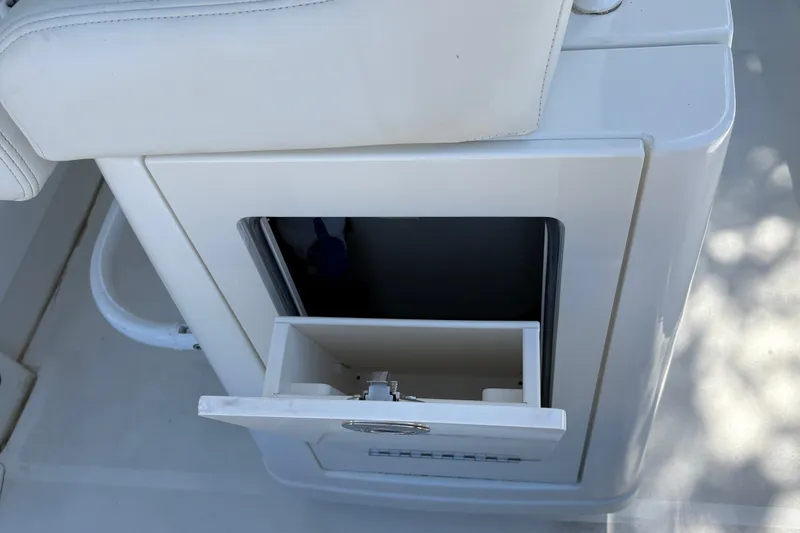 Slide: The Image of Storage compartment on a 2026 Mako 24 APEX boat, featuring a sleek white design. - 40