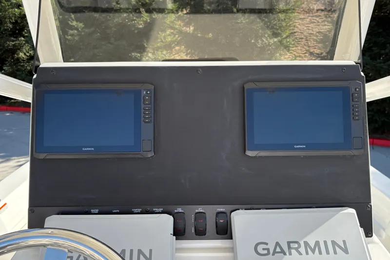 Slide: The Image of Dashboard of 2026 Mako 24 APEX boat featuring dual Garmin displays. - 17
