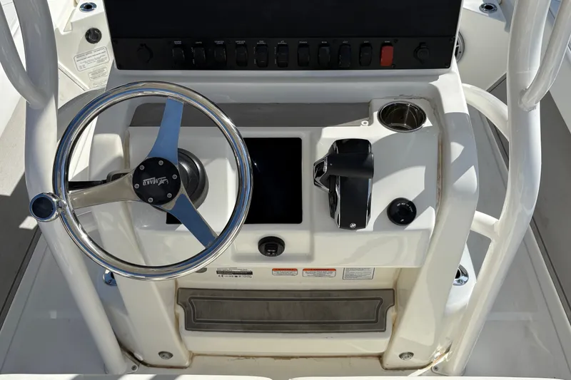 Slide: The Image of 2026 Mako 24 APEX boat console with steering wheel and control panel. - 15