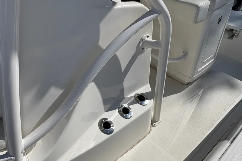 Slide: The Image of 2026 Mako 24 APEX boat interior with rod holders and seating area. - 33