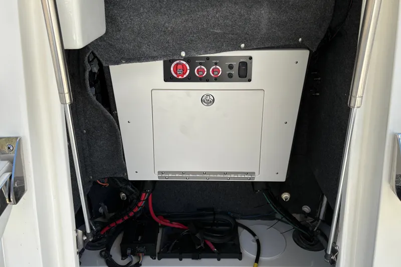 Slide: The Image of Electrical panel inside 2026 Mako 24 APEX boat, featuring switches and wiring. - 24